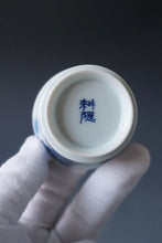 Load image into Gallery viewer, 85ml Qinghua Birds and Banana Tree Porcelain Teacup by KuangShi 青花匡石手绘花鸟蕉荫杯
